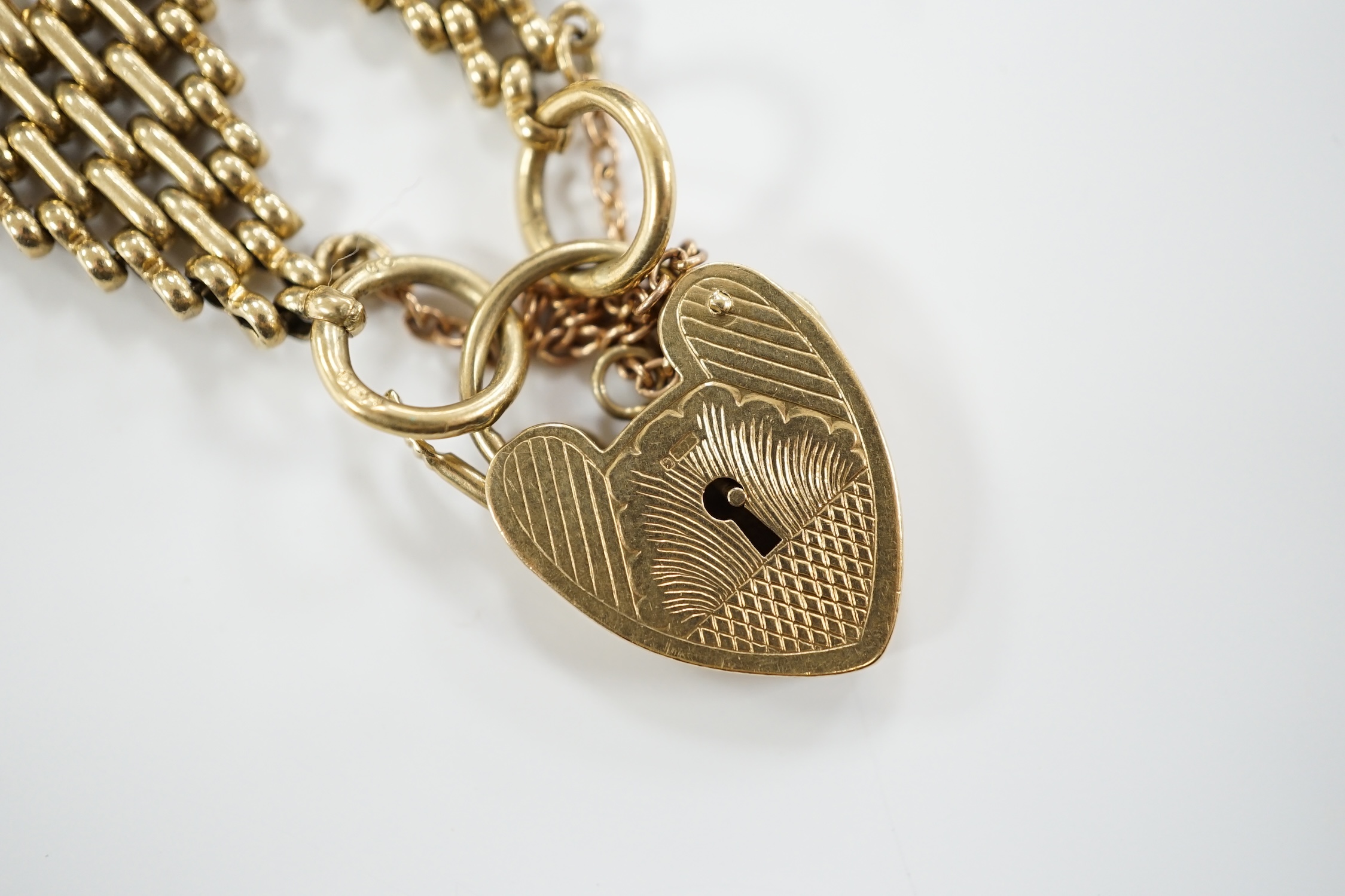 A 1960's 9ct gold gate link bracelet, with heart shaped padlock clasp, 17cm